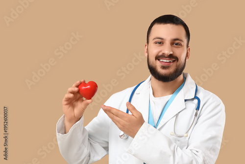 Young happy male doctor wit...