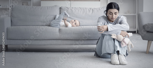 Fotografie Little baby and young mother suffering from postnatal depression at home