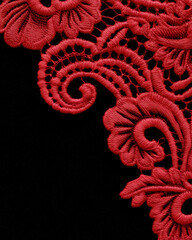 Fashion textile background – red lace embroidery corner border on black, copy space for branding and marketing