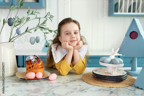 Wallpaper Mural Cute fun child Girl in yellow dress with Easter eggs.Portrait of happy little girl with easter cake on plate, festive decor and bouquet flowers on table. Smiling Girl is cooking for Easter in kitchen Torontodigital.ca