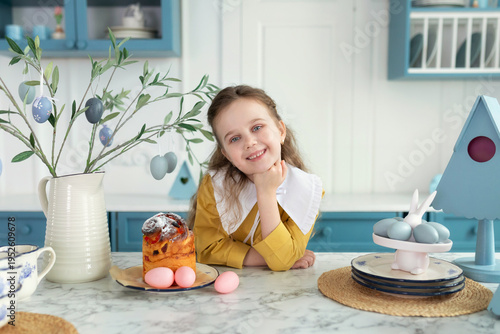 Wallpaper Mural Cute fun child Girl in yellow dress with Easter eggs.Portrait of happy little girl with easter cake on plate, festive decor and bouquet flowers on table. Smiling Girl is cooking for Easter in kitchen Torontodigital.ca