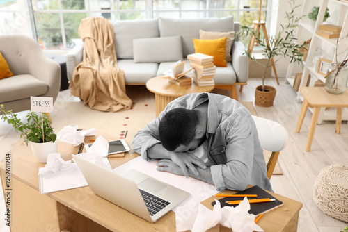 Stressed young man working at home