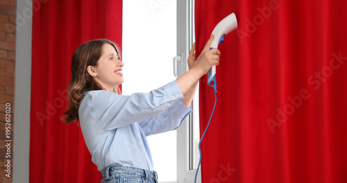 Young woman steaming red cu...