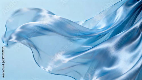 A picture of a blue cloth being swept by the wind. macro. close up. Three-dimensionality. light blue background.Sheer fabric. Satin. close up