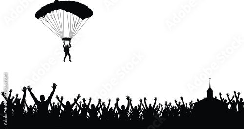 Silhouette of parachuter landing in front of cheering crowd with building people