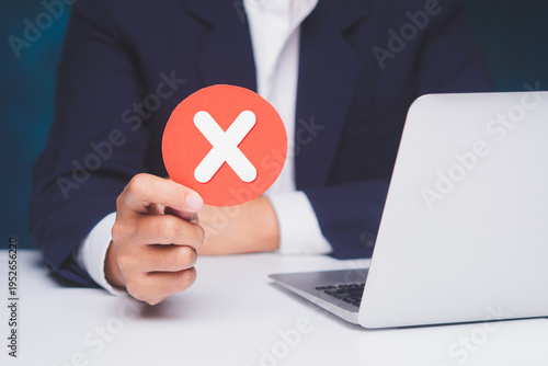 Hand holding cross mark icon for rejection concept