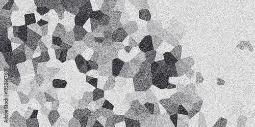 Abstract monochrome mosaic pattern with irregular polygonal shapes and granular noise effect, offering a textured and visually engaging background