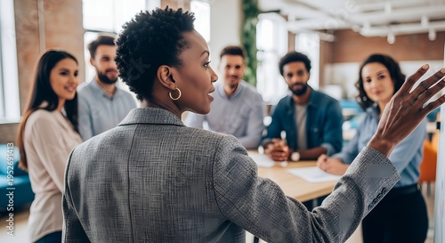 A diverse group of business professionals engaged in a meeting with a woman gesturing