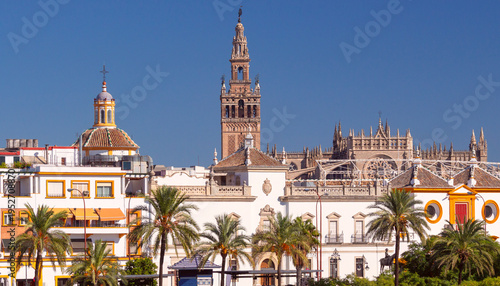 Seville skyline with Giralda tower and cathedral under blue sky Spain