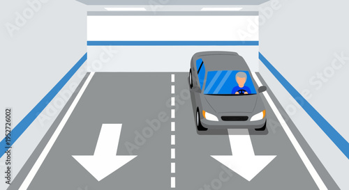 Car driving in a tunnel with directional arrows on the road
