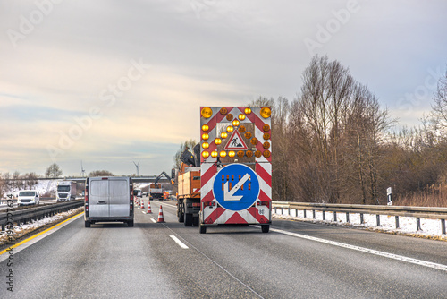 Road maintenance vehicle and traffic cones on highway construction zone. Road repair.