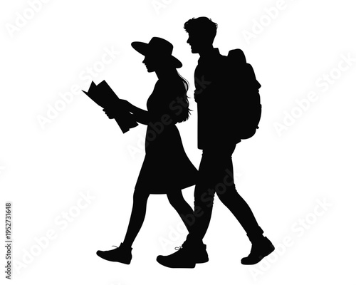 Silhouette of a young couple with backpacks looking at a map while walking together on an adventure