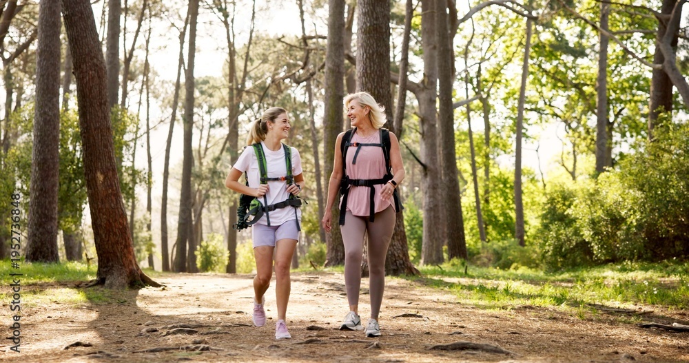 Fototapeta premium Mother, daughter and walking in forest with laughing for fitness adventure, sightseeing and explore nature. Backpack, mature woman and girl in woods with hiking, holiday travel and bonding with joke