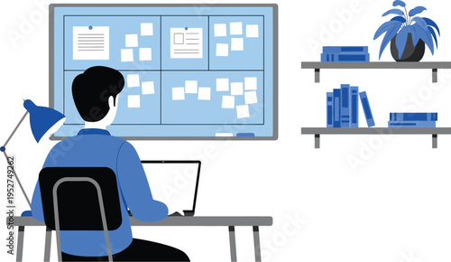 Man working at desk facing large task board