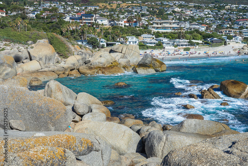 South Africa,Cape Town,Camps Bay,Rocky coastline with turquoise waters and a beach town in the background