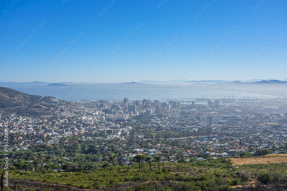 Obraz premium South Africa,Cape Town,Table Mountain,Panoramic view of a coastal city surrounded by hills and ocean under clear blue sky