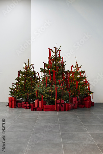 Beautiful Christmas tree indoors with red coloured presents under
