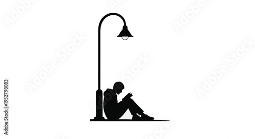 Student sits under a street lamp reading a book during the quiet hours of a dark evening.