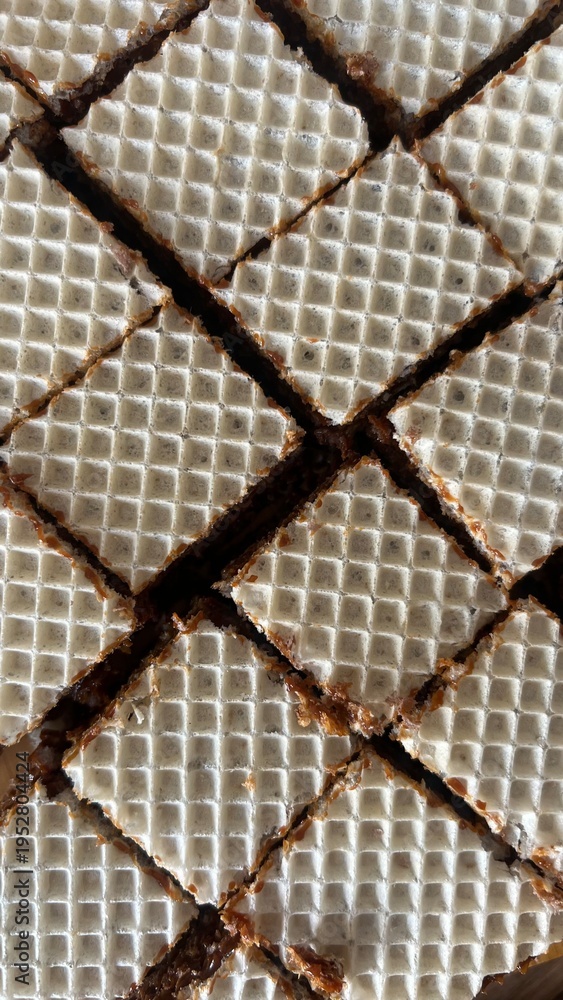 Fototapeta premium Wafer cookies texture with caramel filling, abstract food background pattern