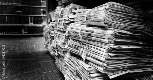 Old Newspaper Papers Bundled on Shelf for Storage and Later Review in Library