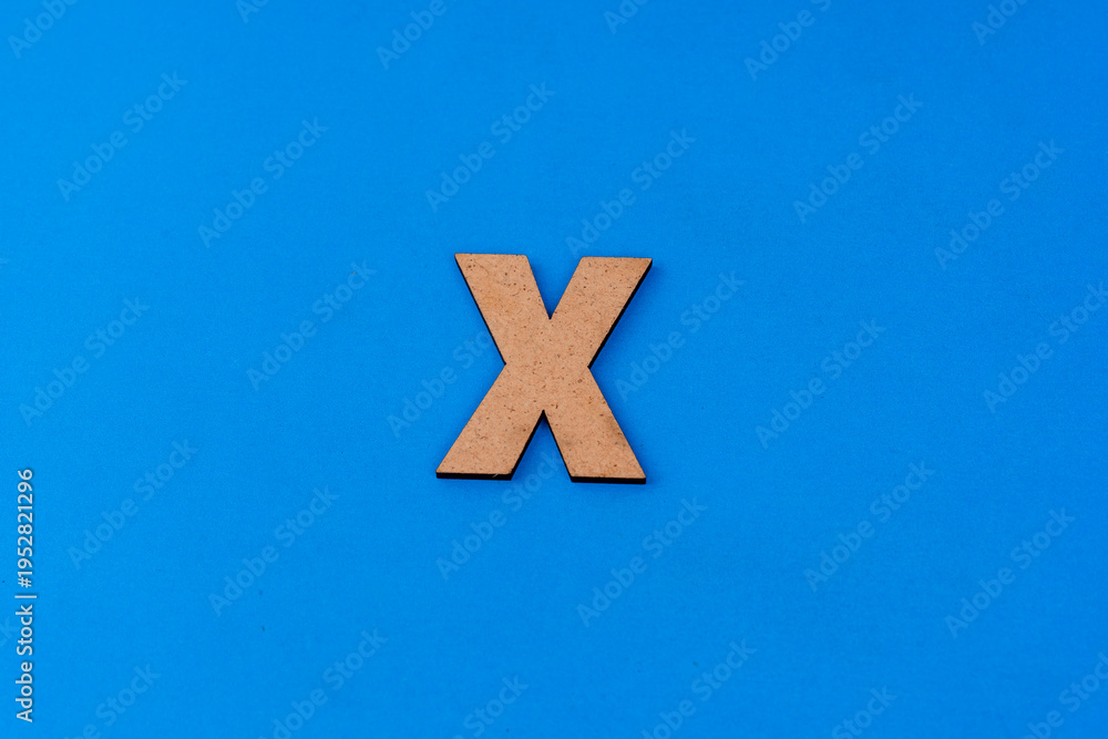 Obraz premium Letter X on paper on a blue background