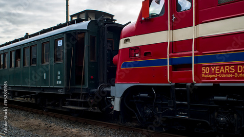Vintage locomotive coupled to passenger carriage