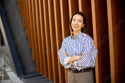 Woman standing smiling near...
