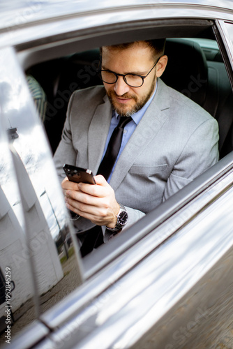 Businessman checks phone wh...
