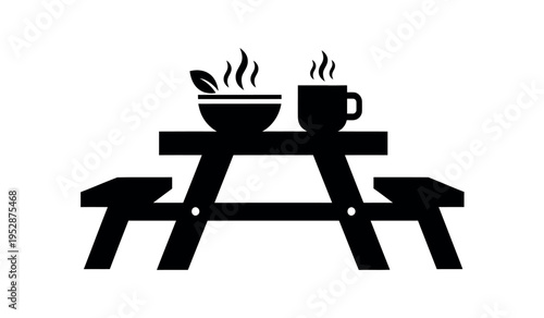 Picnic table with steaming cup and bowl