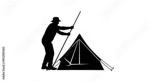 Man setting up a tent with a long pole for camping or outdoor activities in the wilderness with a hat on