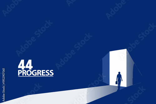 A businessman walks toward bright light emanating from a doorway