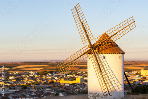 Historic windmill standing over Mota del Cuervo at sunset