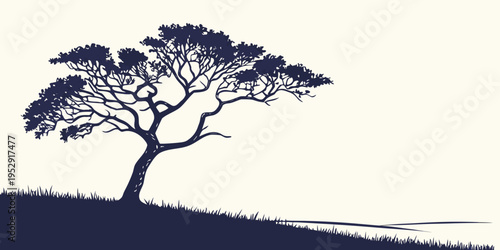 A solitary tree stands tall on a gentle hill under a clear sky.