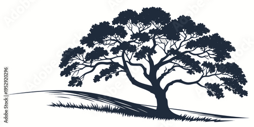 A solitary tree stands tall on a grassy hill under a clear sky.