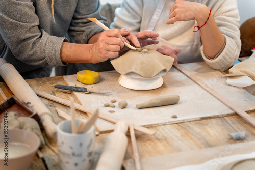 Crafting clay pottery at a ceramics workshop, learning traditional handicraft techniques