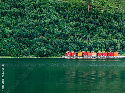 Red boat houses on a green lake in Scandinavia