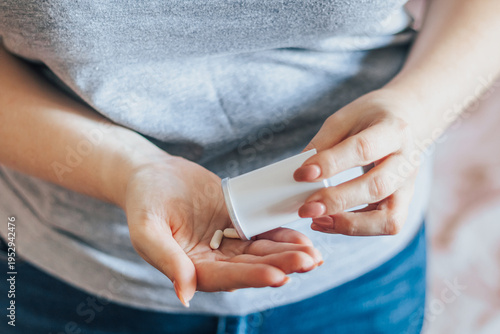 Woman is taking pills. World Health Day. Hands holding medical bottle with capsules. Health care concept.