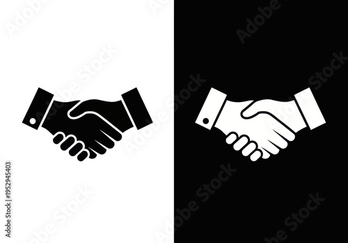Two business hands shake in a formal agreement on white and black backgrounds.
