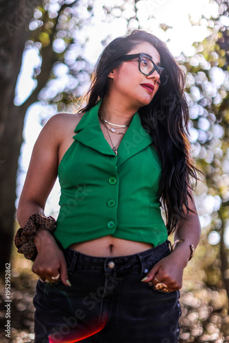 A close up head shot portrait of a preppy, young, beautiful, confident and attractive Mexican woman. Enjoying her happy life. Happy young girl