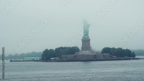 Dramatic fog surrounding Statue of Liberty in New York Harbor