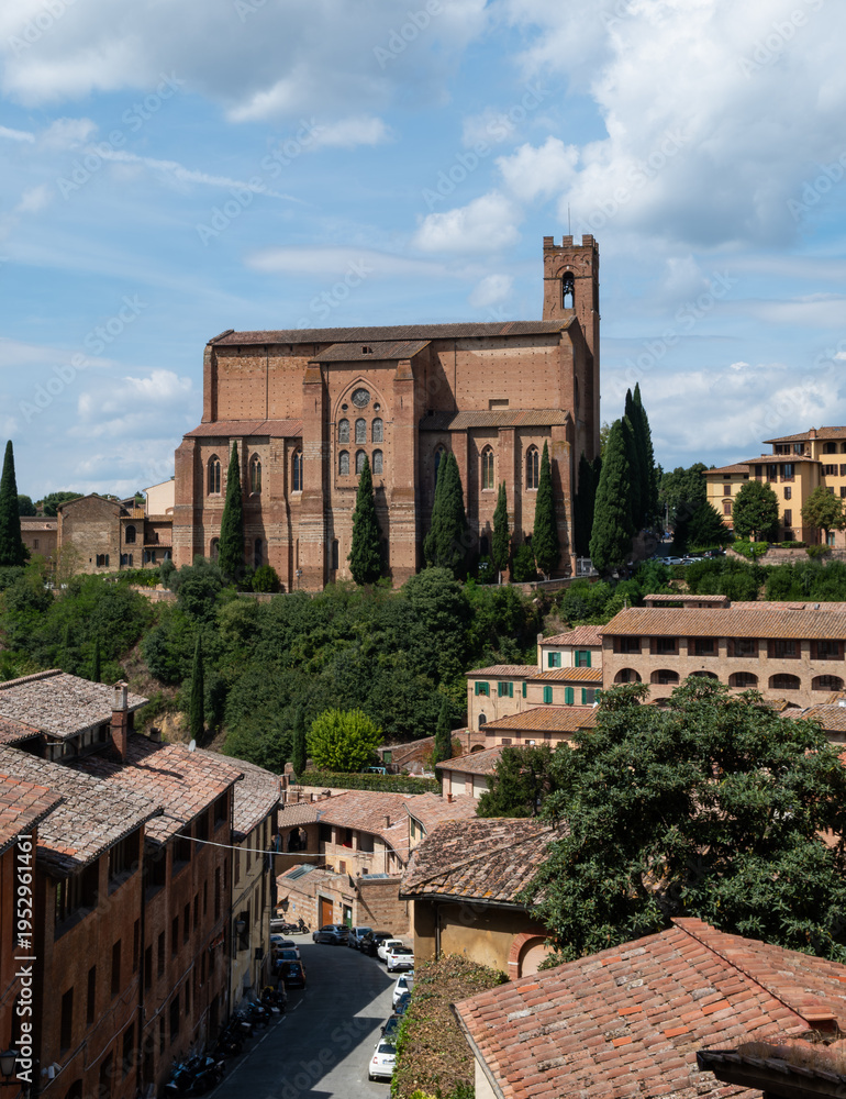 Obraz premium Hilltop Gothic church overlooking historic Italian town