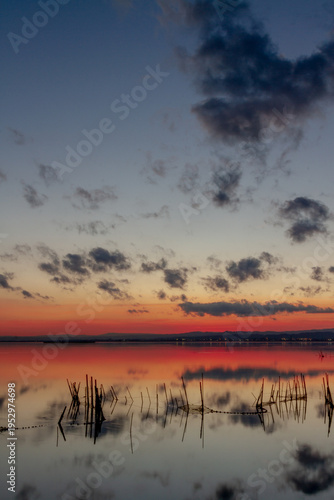 Sunset at the Albufera lagoon in Valencia, Spain, with orange and dark blue tones.