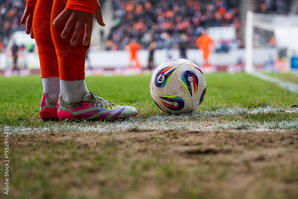 Fototapeta premium Football match between KGHM Zaglebie Lubin vs Lech Poznan. Detail of player's legs and the ball in the corner.