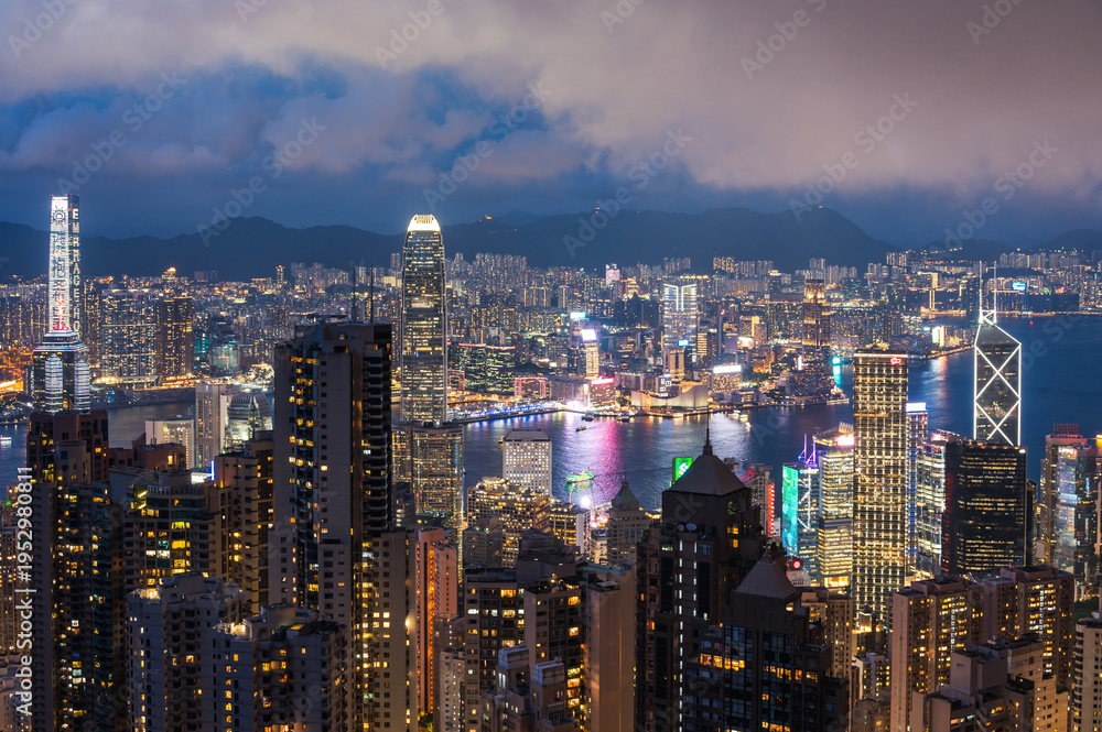 Obraz premium View of Hong Kong and Kowloon from Victoria peak. Evening, sunset. Panorama of Hong Kong, skyscrapers and nature. 21 May 2025, Hong Kong, China
