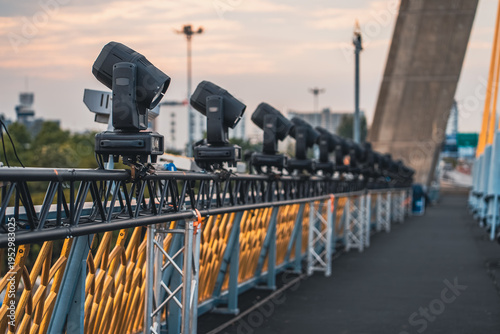 Φωτογραφία spotlights and projector lamps illuminating cable-stayed bridge at night, profes
