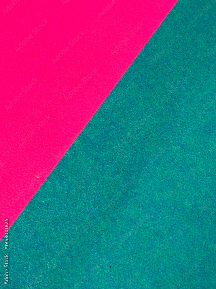 Fototapeta premium Abstract geometric pattern on a pink and green carpet