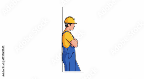 A worker wearing yellow and blue clothes standing by a wall.