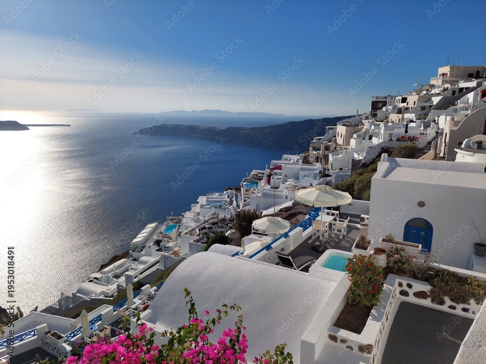Fototapeta premium Whitewashed houses with terraces and pools and a beautiful view in Imerovigli on Santorini island, Greece