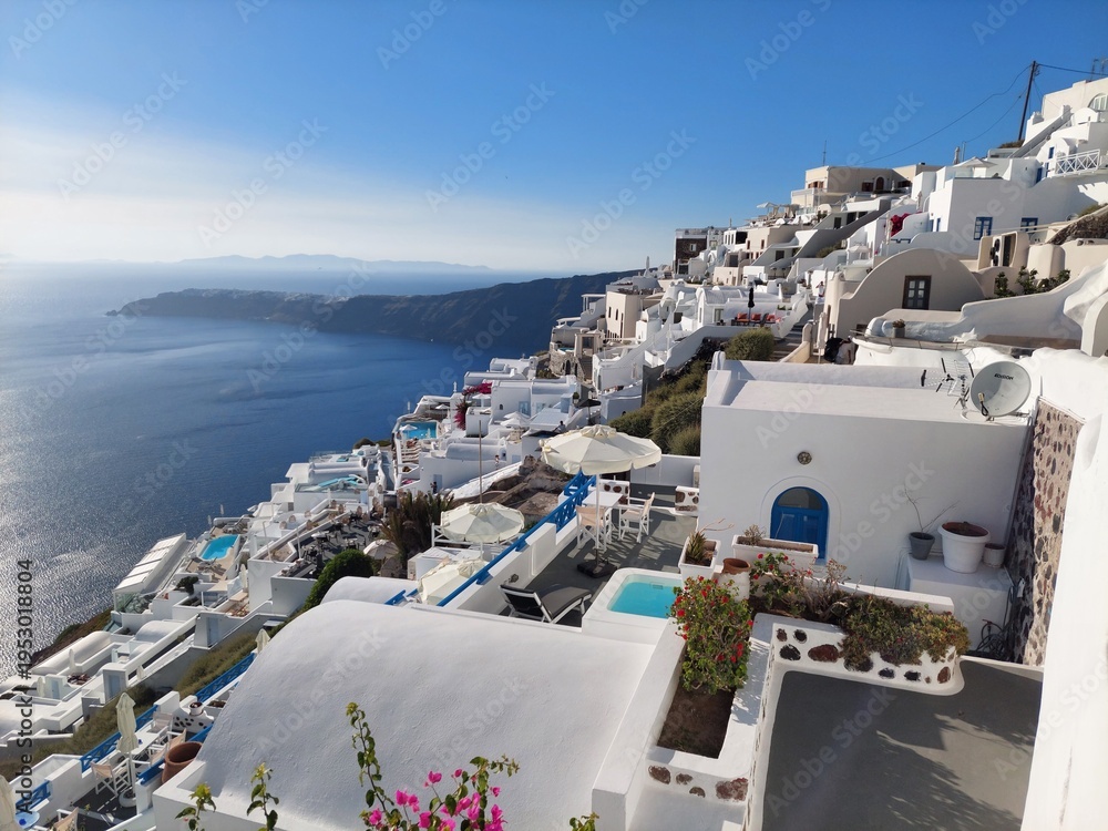 Fototapeta premium Whitewashed houses with terraces and pools and a beautiful view in Imerovigli on Santorini island, Greece