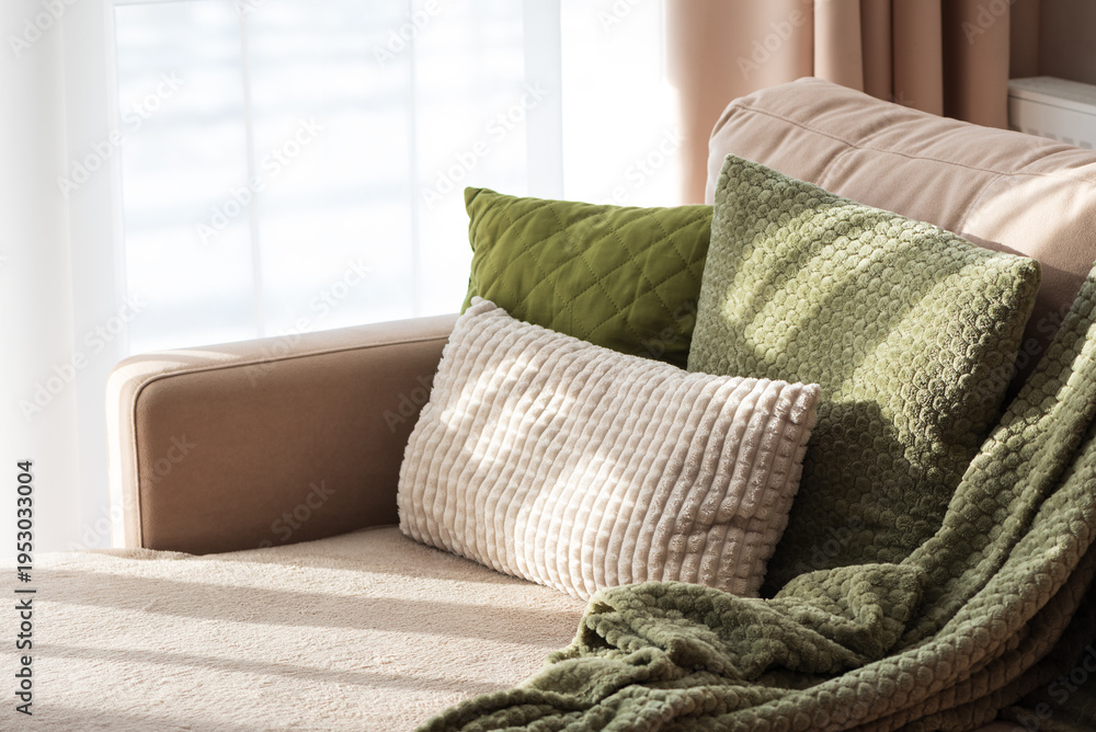Fototapeta premium Textured Pillows and Blanket on Sofa. Cozy Spring Home Interior